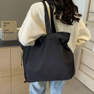Women's large drawstring travel bag in black, aesthetic nylon shoulder bag for everyday work travel and casual use